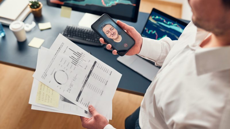 Businessman trading stocks online. Stock investor discussing numbers at graphs while video conversation with his colleague. Business team planning and analyzing stock market graphs. Man working with stock chart data. Business man investing stock using online platform. Business success concept